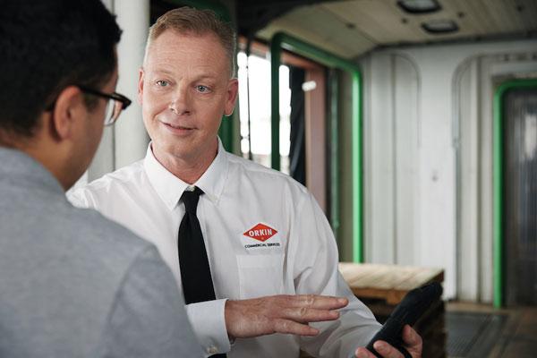 An Orkin Pro pointing to a tablet-600x400