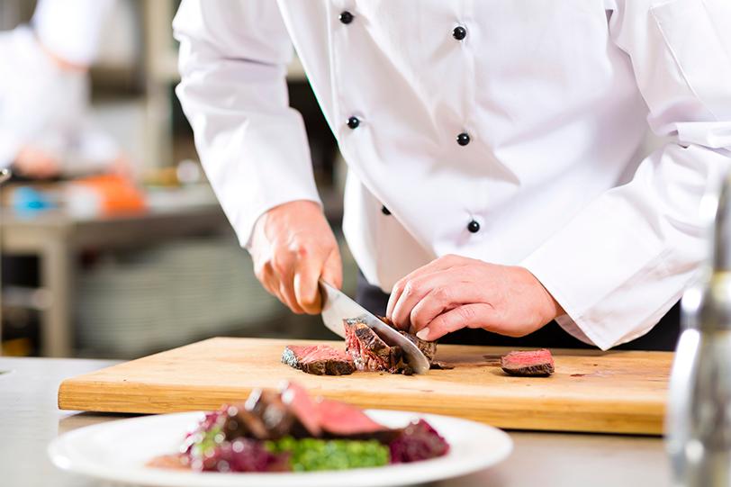 Chef Cutting a Steak